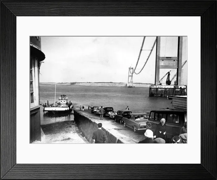 Framed Print : Severn Bridge - Cars queue to use the Aust Severn ferry with the Severn Bridge towering Framed Print : Severn Bridge - Cars queue to use the Aust Severn ferry with the Severn Bridge towering