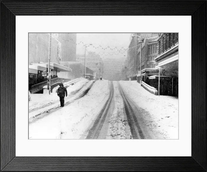 Framed Print : A lone pedestrian walks down Corporation Street near Lewiss Store. Birmingham