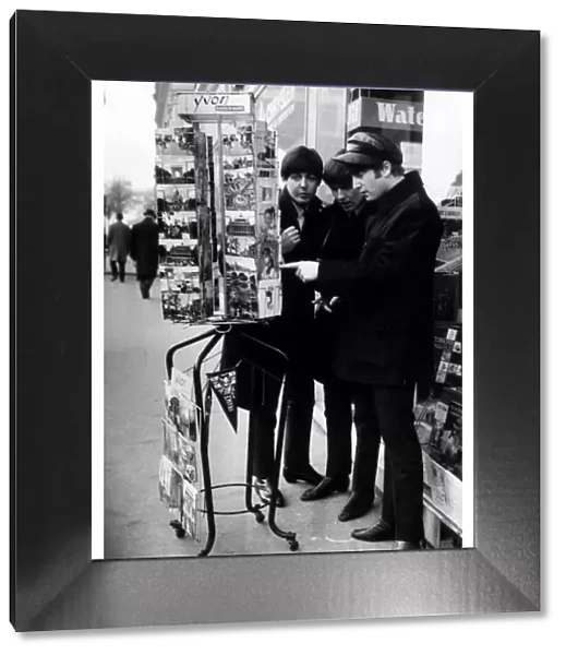 Paul McCartney, George Harrison and John Lennon of the Beatles pop group looking at