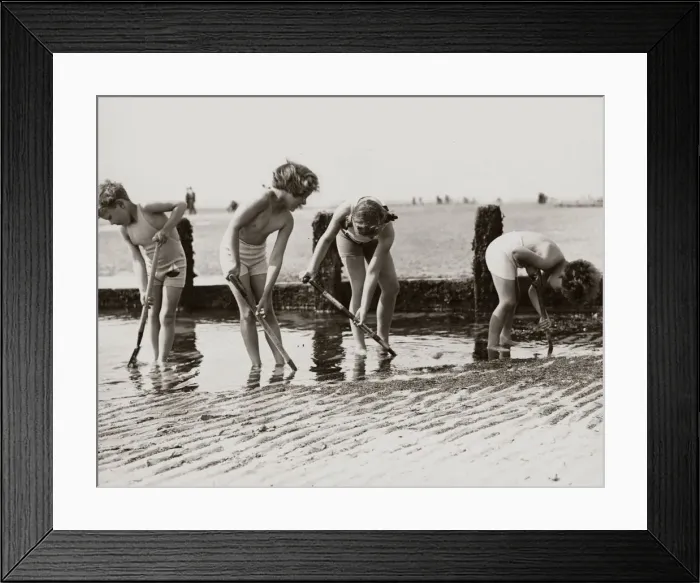 Framed Print : Young children looking for crabs and other beach life hiding in the sands on the beach Framed Print : Young children looking for crabs and other beach life hiding in the sands on the beach