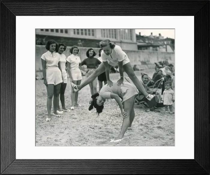 Framed Print : Ocean chorus girls playing leap frog on a beach at Clacton on Sea Playing Framed Print : Ocean chorus girls playing leap frog on a beach at Clacton on Sea Playing