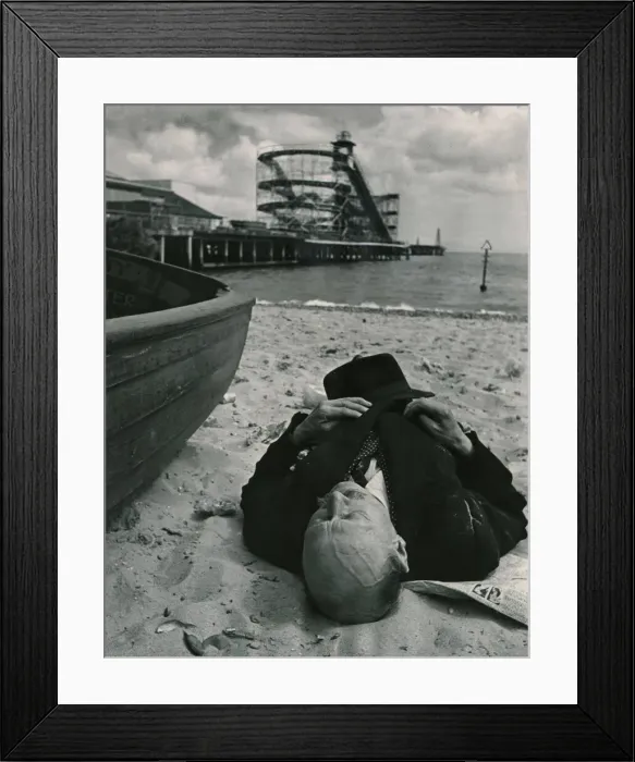 Framed Print : Sheltered from the squalls in the Whitsun sunshine this holiday maker sleeps on the beach