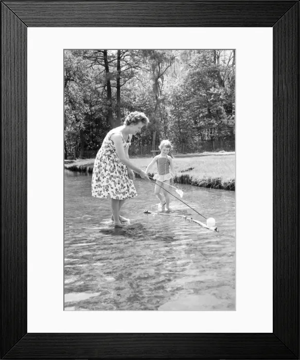 Framed Print : A little girl splashes away with her mother in a stream just inside the main gate of