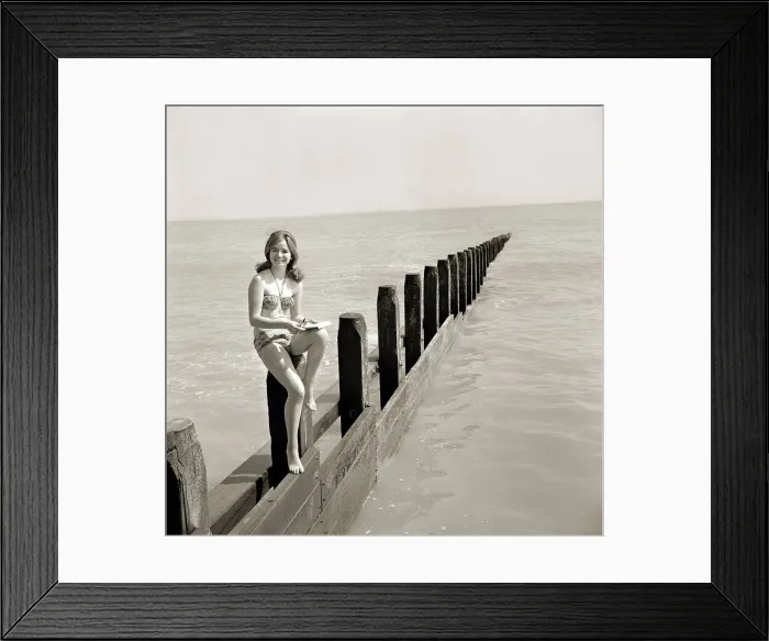 Framed Print : Butlins Holiday Camp at Bognor A young woman wearing a bikini sitting on a barrier Framed Print : Butlins Holiday Camp at Bognor A young woman wearing a bikini sitting on a barrier
