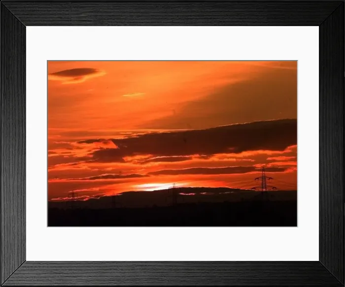 Framed Print : Powerlines cross the farmland just outside Lichfield as the Sun sets Framed Print : Powerlines cross the farmland just outside Lichfield as the Sun sets