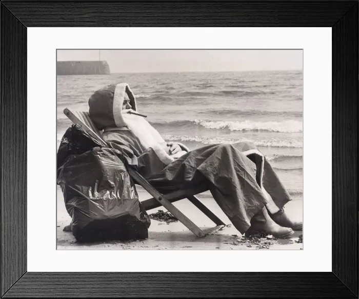 Framed Print : Father Christmas resting in a deckchair besides the sea at Scarborough May 1978