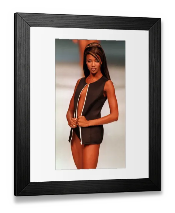 Framed Print : Naomi Campbell models an outfit by the designer Genny at Milan Fashion Week, October 1995