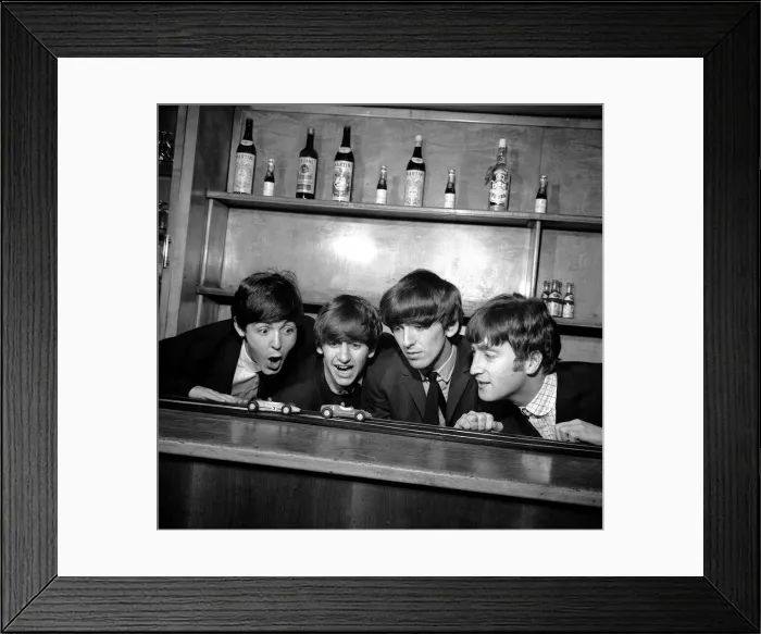 Framed Print : The Beatles in Coventry, amusing themselves with a miniture car race track before Framed Print : The Beatles in Coventry, amusing themselves with a miniture car race track before