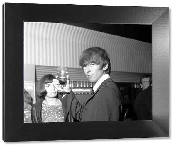 George Harrison raises his glass at the Prince of Wales Theatre, Leicester Square