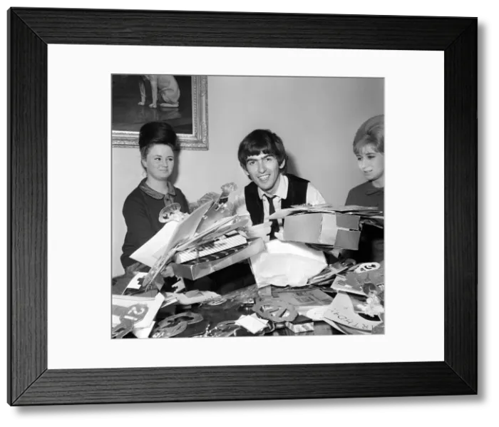 Framed Print : George Harrison, 21st birthday, with fan-club secretary Anne Collingham helping him sort Framed Print : George Harrison, 21st birthday, with fan-club secretary Anne Collingham helping him sort