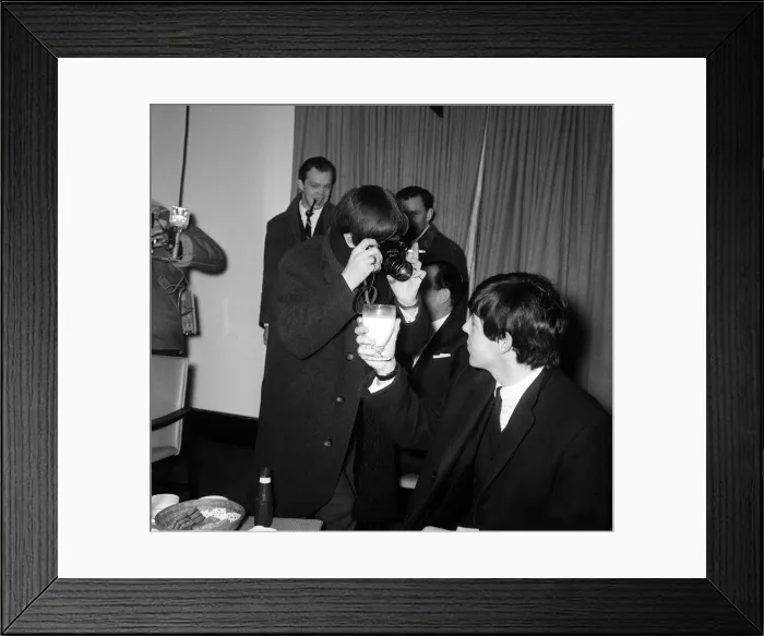 Framed Print : Ringo Starr taking pictures of Paul McCartney holding a glass of milk at Hethrow before