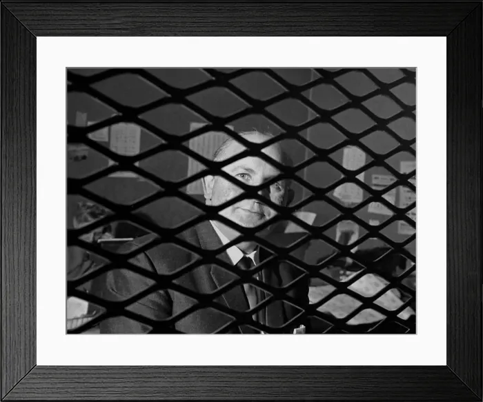 Framed Print : Bookmaker Sidney Glanz pictured through the grill inside his betting shop in the Isle of Framed Print : Bookmaker Sidney Glanz pictured through the grill inside his betting shop in the Isle of