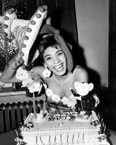 Cardiff-born singer Shirley Bassey is pictured celebrating her 19th birthday with a cake