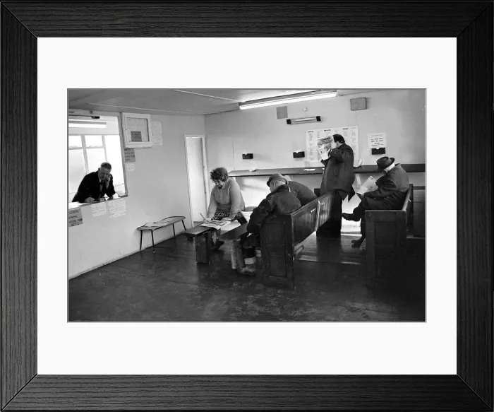 Framed Print : Punters seated on church pews as they study the guide before placing a bet at Mac Framed Print : Punters seated on church pews as they study the guide before placing a bet at Mac