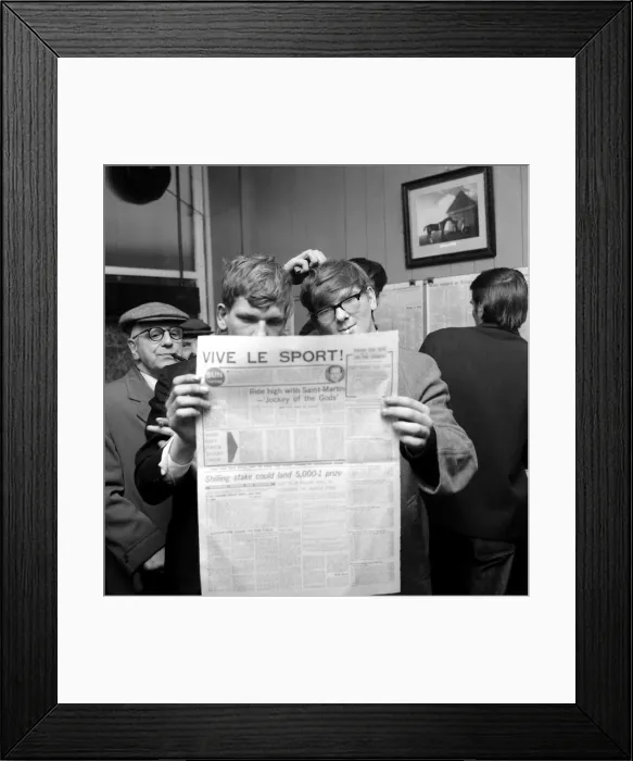 Framed Print : Punters studying the form guide in a French newspaper before placing their bets Framed Print : Punters studying the form guide in a French newspaper before placing their bets