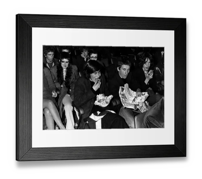 Framed Print : Music fans eat their fish and chips at the Sophia Gardens Pavilion in Cardiff whilst Framed Print : Music fans eat their fish and chips at the Sophia Gardens Pavilion in Cardiff whilst