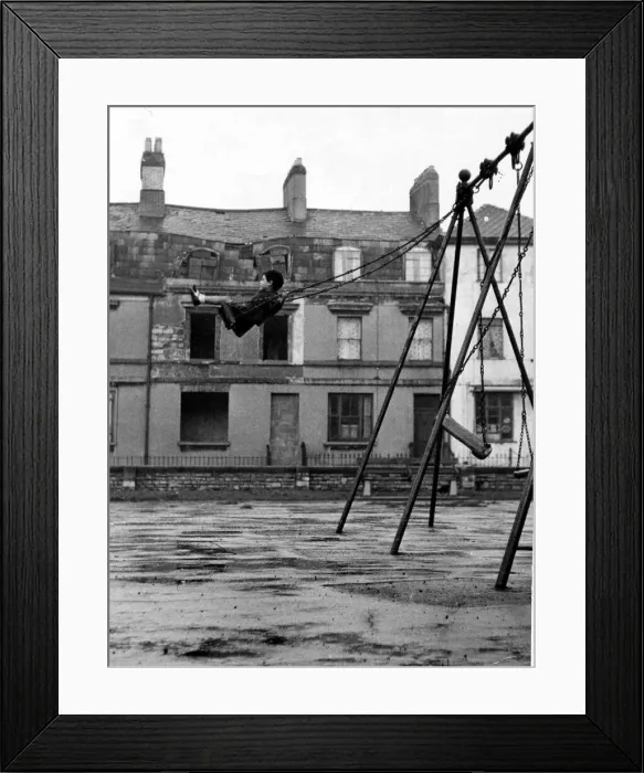 Framed Print : A youngster enjoys the swing in a playground in the docks of Butetown in Cardiff Framed Print : A youngster enjoys the swing in a playground in the docks of Butetown in Cardiff