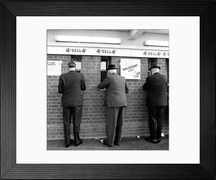 Framed Print : Men placng bets at the tote before a race October 1969 Framed Print : Men placng bets at the tote before a race October 1969