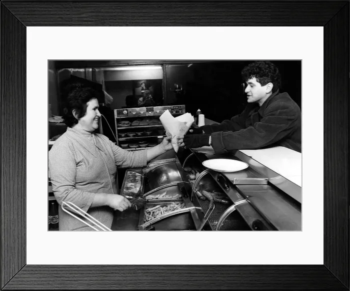 Framed Print : Mrs Maria Stavri serves a customer in a Cardiff fish and chip shop. March 1984 Framed Print : Mrs Maria Stavri serves a customer in a Cardiff fish and chip shop. March 1984