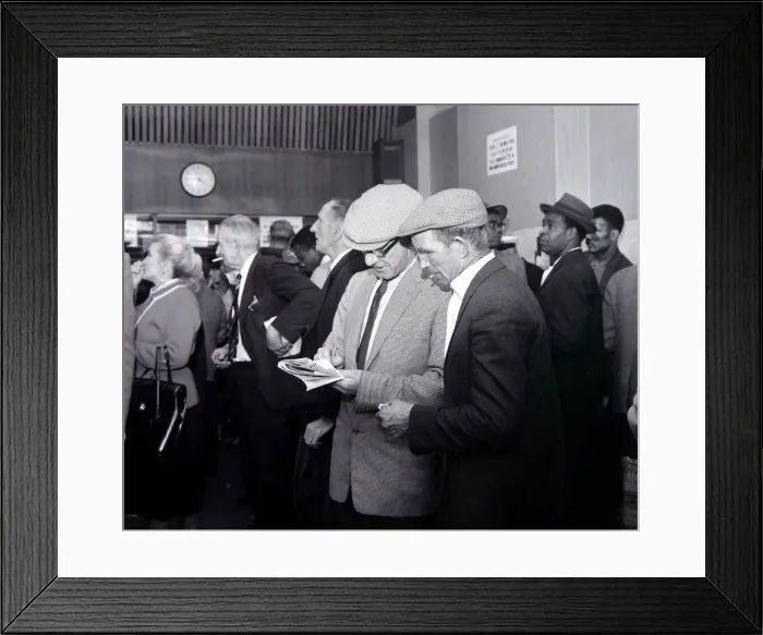 Framed Print : A busy scene inside a betting shop with punters queuing to make bets minutes before Framed Print : A busy scene inside a betting shop with punters queuing to make bets minutes before