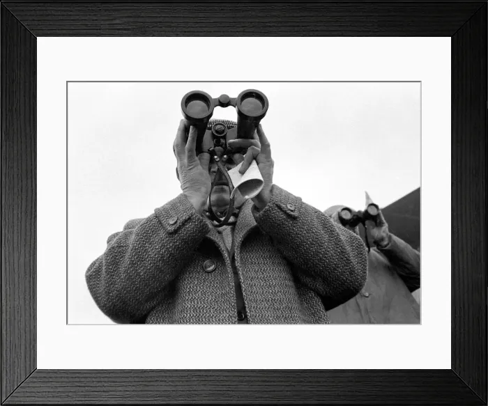 Framed Print : A punter watching the race through binoculars after making his bet march 1963