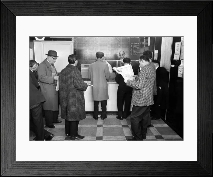 Framed Print : A queue of punters waiting to place bets in the shop before a race March 1963 Framed Print : A queue of punters waiting to place bets in the shop before a race March 1963