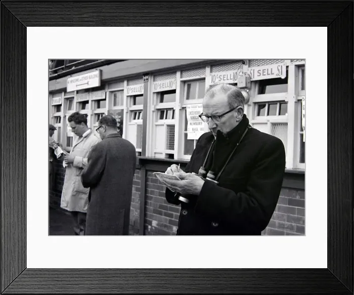 Framed Print : A punter making notes before placing his bet during a day out at the races March Framed Print : A punter making notes before placing his bet during a day out at the races March