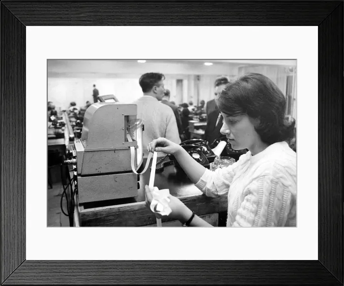 Framed Print : A worker at Ladbrokes betting shop watching the tape machine December 1967 Framed Print : A worker at Ladbrokes betting shop watching the tape machine December 1967
