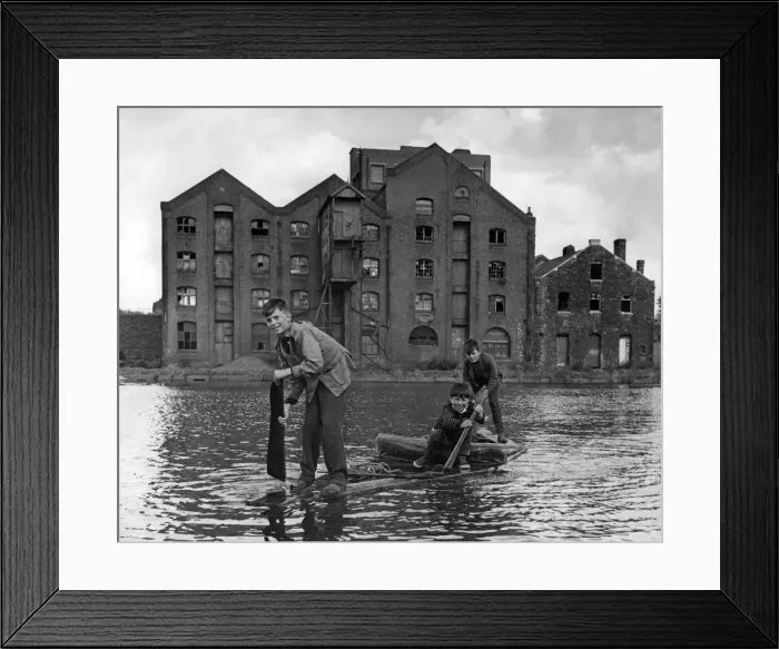 Framed Print : Three young boys from Cardiff paddle across the old Cardiff West Dock on their homemade Framed Print : Three young boys from Cardiff paddle across the old Cardiff West Dock on their homemade