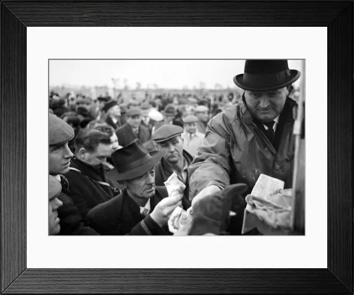 Framed Print : Bookmaker taking bets from crowds of punters before the race at Leopardstown in Ireland Framed Print : Bookmaker taking bets from crowds of punters before the race at Leopardstown in Ireland