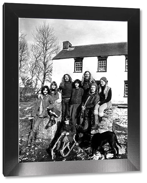Communes - Eight members of the commune pose in the sunshine outside their farmhouse at