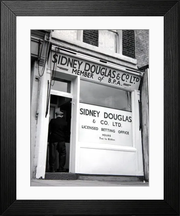 Framed Print : An exterior view of Sidney Douglas betting shop in Mile End Road London May 1961