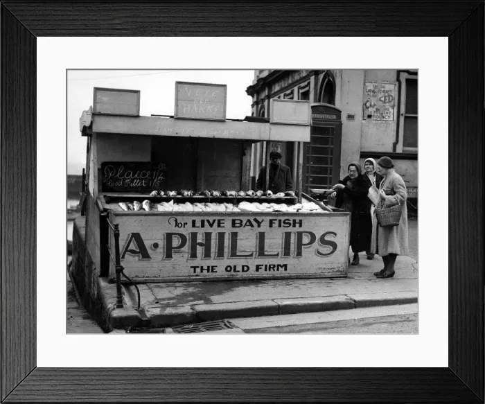 Framed Print : Mrs Phillips serving customers at her stall in Princes Street, Bridnlington Framed Print : Mrs Phillips serving customers at her stall in Princes Street, Bridnlington
