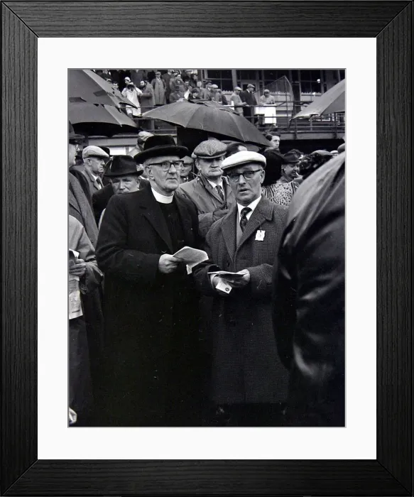 Framed Print : A priest holds his guide during a day out at the races in Cheltenham March 1963