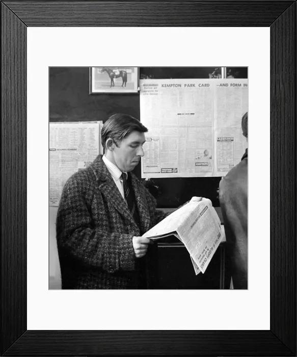 Framed Print : A punter checks the racing guide in a newspaper before making his bet at a race Framed Print : A punter checks the racing guide in a newspaper before making his bet at a race