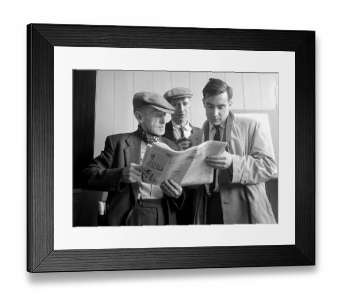 Framed Print : Punters studying the form guide before placing a bet at William Massey betting shop in Framed Print : Punters studying the form guide before placing a bet at William Massey betting shop in