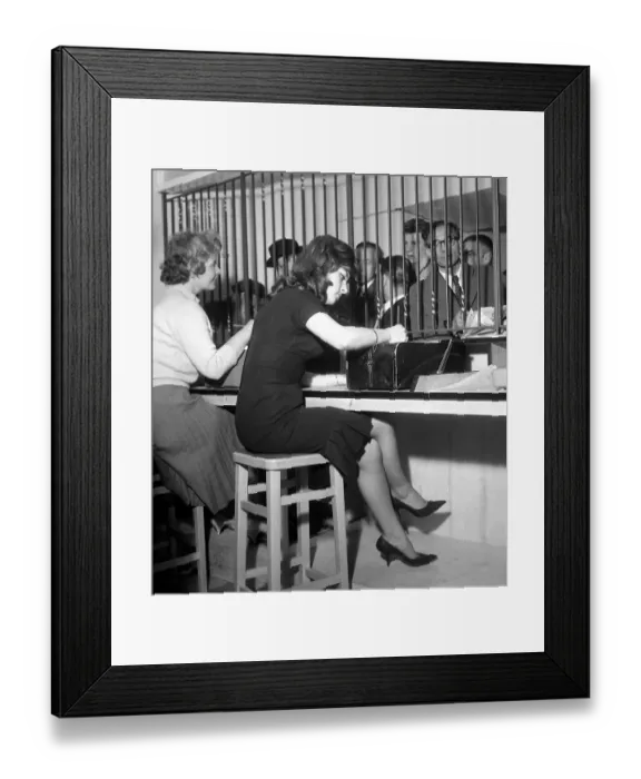 Framed Print : Bookies clerks taking bets from punters at a busy betting shop in Soho