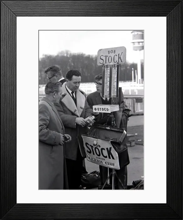 Framed Print : Bookmakers checks his takings after bets were placed for the race March 1963