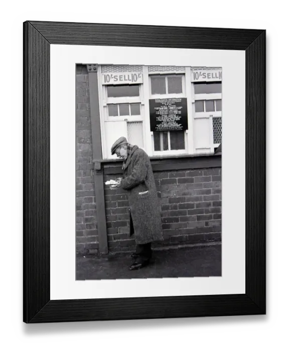 Framed Print : An elderly man holding his receipts after placing a bet on the tote before a race Framed Print : An elderly man holding his receipts after placing a bet on the tote before a race