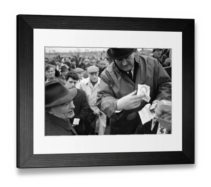 Framed Print : Bookmaker taking bets from crowds of punters before the race at Leopardstown in Ireland
