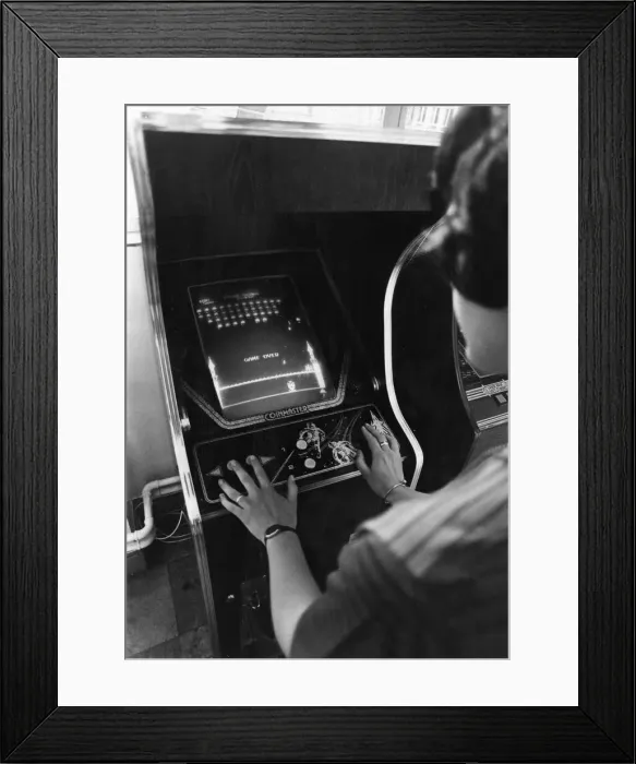 Framed Print : A teenager plays Space Invaders at an amusements arcade in Cardiff June 1981 Framed Print : A teenager plays Space Invaders at an amusements arcade in Cardiff June 1981