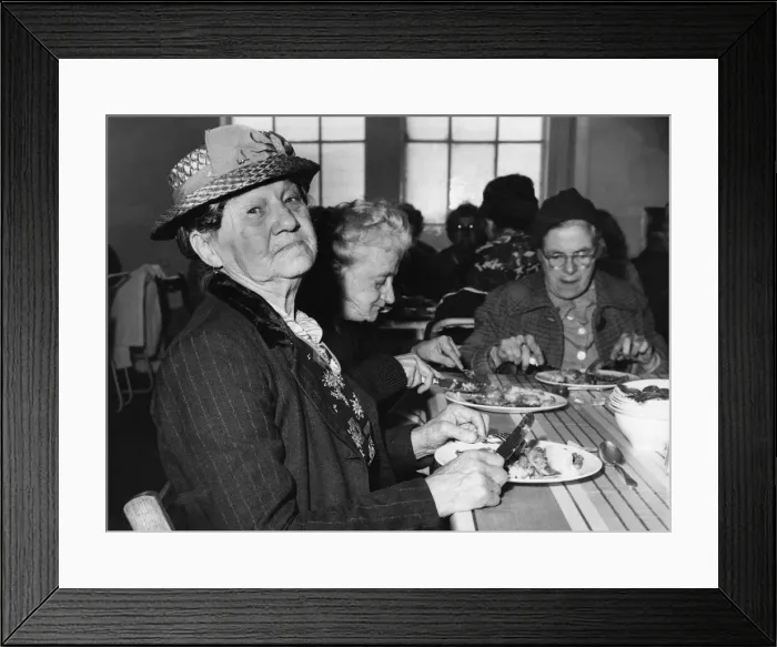 Framed Print : Mrs Agnes Efferman, from Marion Street, Splott, Cardiff tucks into her one Framed Print : Mrs Agnes Efferman, from Marion Street, Splott, Cardiff tucks into her one