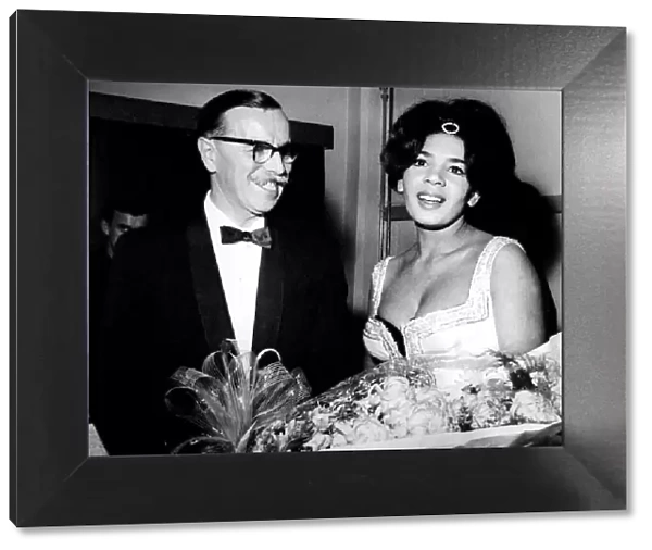Shirley Bassey is presented with flowers by the General Manager of the Capitol Theatre