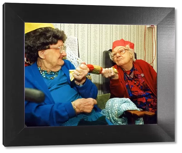 97 year olds Alison Lewis and Elizabeth Llewellyn pulling a cracker November