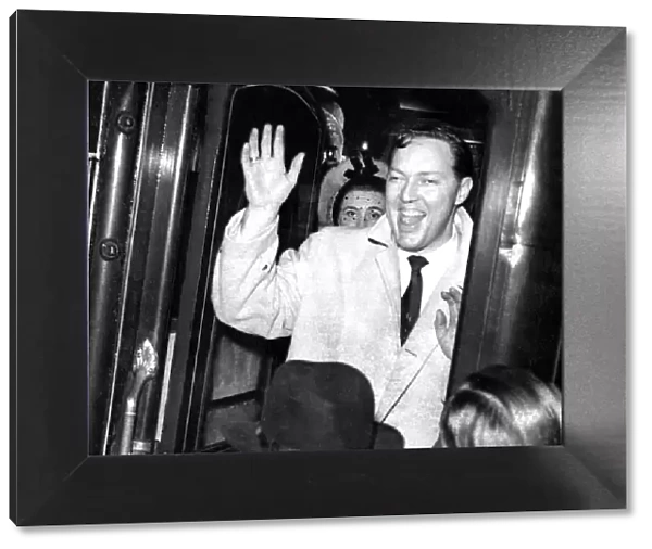 Bill Haley and his Comets wave goodbye to fans as he boards a train March 1957