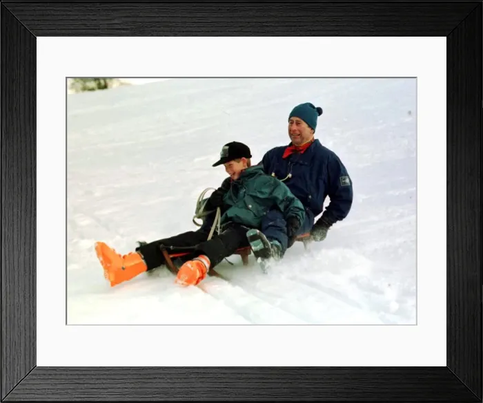 Framed Print : Prince Charles on a sledge with Prince Harry while on holiday in Klosters Switzerland