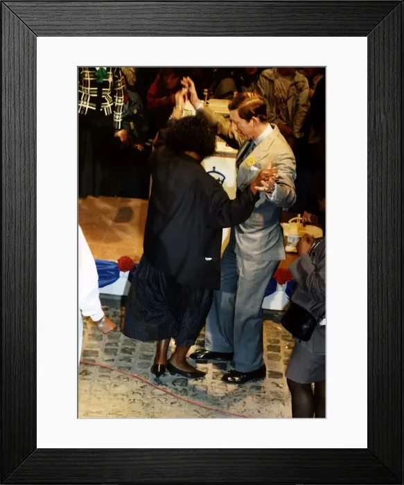 Framed Print : HRH Prince Charles dances with a member of the crowd during 40th birthday celebrations Framed Print : HRH Prince Charles dances with a member of the crowd during 40th birthday celebrations