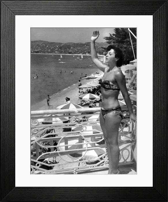 Framed Print : Yolande Blatt waves a friend from the Casino Terrace during her holidays July 1949