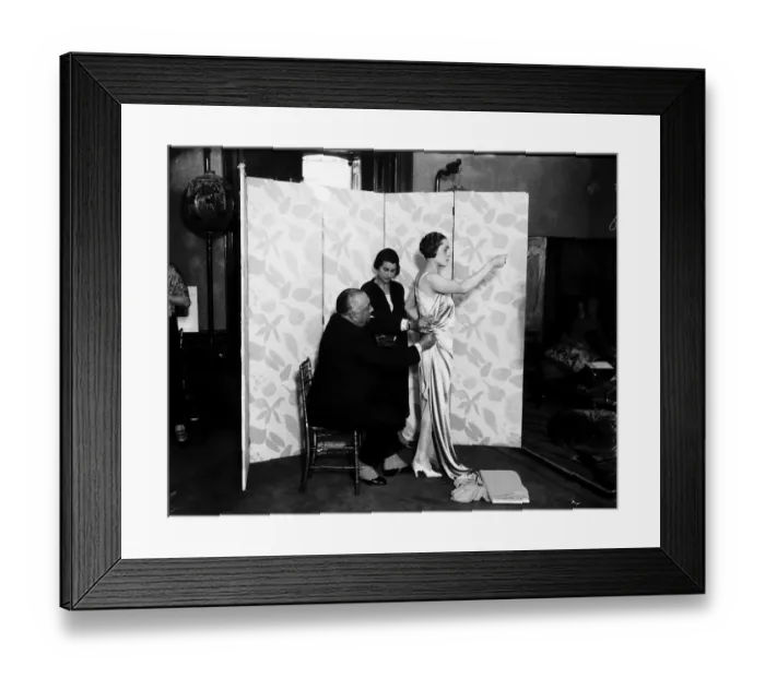 Framed Print : Paul Poiret designing a gown on one of his Mannequins October 1924 Framed Print : Paul Poiret designing a gown on one of his Mannequins October 1924