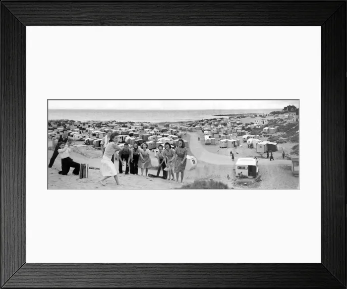 Framed Print : Men and women play a game of cricket on the sand beach. Holidays in Britain Framed Print : Men and women play a game of cricket on the sand beach. Holidays in Britain